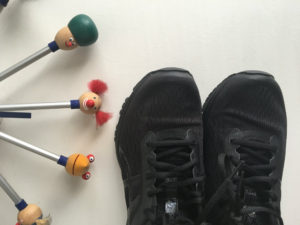 exercise can generate a positive mindset for mental health recovery. image shows a picture of laced up sneakers and a section of a kelner clock