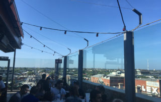 blue sky and people drinking at a rooftop in melbourne