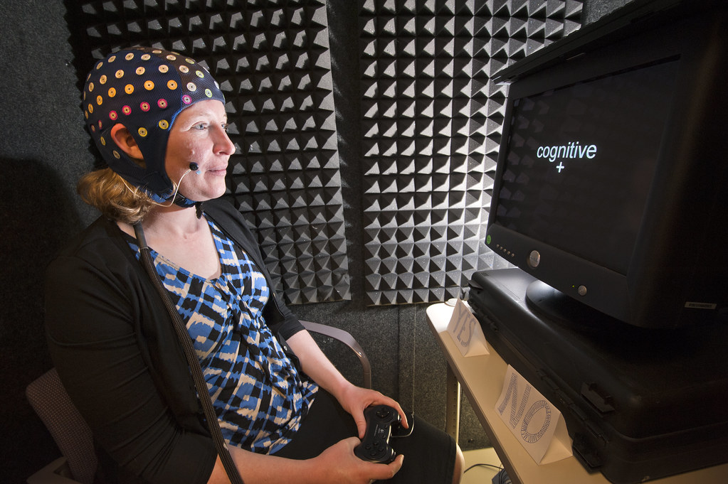 cognitive training for schizophrenia - brain training games - woman with sensors on her skull playing cognitive games with a computer screen in front of her