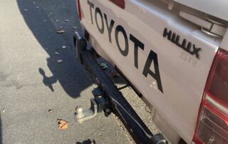 toyotao hilux with ball of aluminium foil nearby and some leaves and detritous