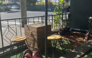 red sandals in the sun under a pergola